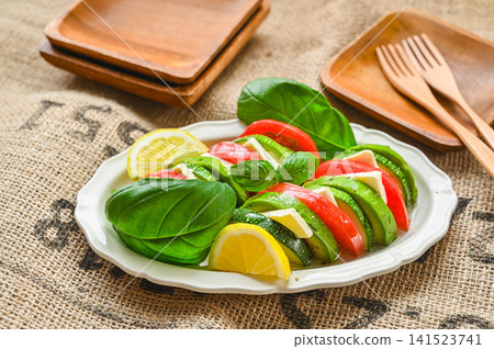 Caprese-style salad with zucchini, avocado, and tomato Caprese-style salad with zucchini, avocado, and tomato 141523741