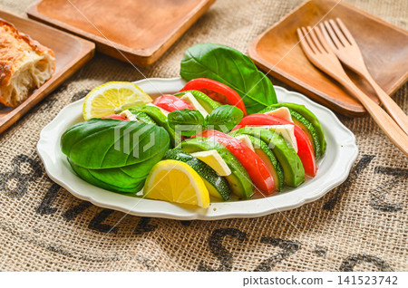 Caprese-style salad with zucchini, avocado, and tomato Caprese-style salad with zucchini, avocado, and tomato 141523742