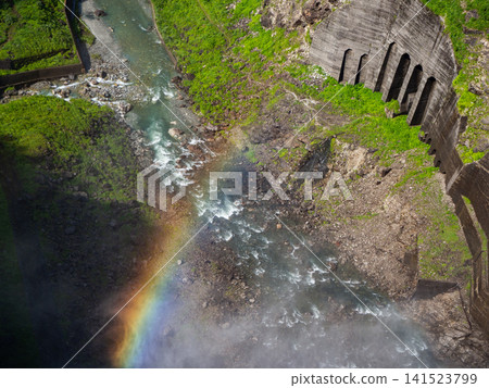 A rainbow over the tourist-oriented water release at Kurobe Dam, Omachi City, Nagano Prefecture. A rainbow over the tourist-oriented water release at Kurobe Dam, Omachi City, Nagano Prefecture. 141523799