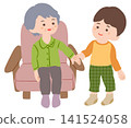 A grandmother sitting on a sofa and a boy standing beside her. A grandmother sitting on a sofa and a boy standing beside her. 141524058