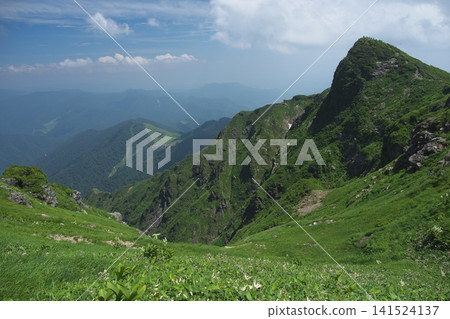 Sheer rock peaks and deep green mountain slopes Sheer rock peaks and deep green mountain slopes 141524137