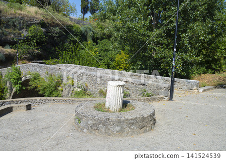 A paved walkway with a circular stone structure and a stump in Podgorica, Montenegro A paved walkway with a circular stone structure and a stump in Podgorica, Montenegro 141524539