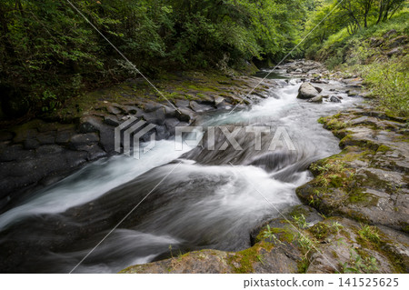 A clear waterfall flowing in summer A clear waterfall flowing in summer 141525625