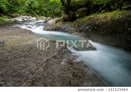 A clear waterfall flowing in summer A clear waterfall flowing in summer 141525664