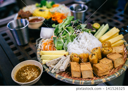 healthy vegetarian spring rolls with rice noodles tofu and fresh organic vegetables, colorful vegan asian food platter with fresh salad noodles tofu and dipping sauce healthy vegetarian spring rolls with rice noodles tofu and fresh organic vegetables, colorful vegan asian food platter with fresh salad noodles tofu and dipping sauce 141526325