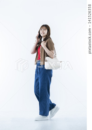 Young woman talking on a smartphone Young woman talking on a smartphone 141526358