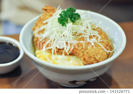fried pork and rice, pork ball or Breaded Pork Cutlet Bowl or Butadon or Deep fried Pork Cutlet on Rice or Japanese pork cutlet or Tonkatsu fried pork and rice, pork ball or Breaded Pork Cutlet Bowl or Butadon or Deep fried Pork Cutlet on Rice or Japanese pork cutlet or Tonkatsu 141526771