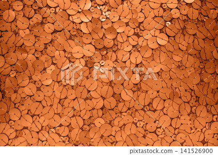 Close-up orange sequin texture background with circular glitter pattern and reflective shimmer Close-up orange sequin texture background with circular glitter pattern and reflective shimmer 141526900