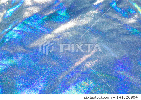 Iridescent blue holographic fabric with shimmering glitter texture and soft folds Iridescent blue holographic fabric with shimmering glitter texture and soft folds 141526904