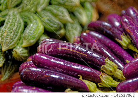 Fresh Long Purple Eggplants and Bitter Melons at Market Fresh Long Purple Eggplants and Bitter Melons at Market 141527068
