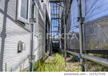 The old exterior wall and temporary scaffolding immediately after the start of the exterior wall renovation. The old exterior wall and temporary scaffolding immediately after the start of the exterior wall renovation. 141527430