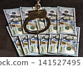 Handcuffs on one hundred banknotes of US dollars 141527495