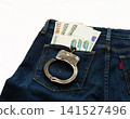 In jeans pocket money and handcuffs are euro banknotes and rubles 141527496