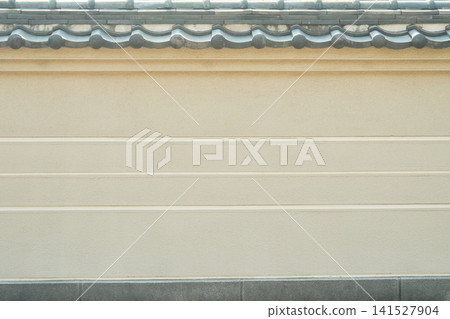 The temple's traditional earthen walls and tiled roof evoke a sense of Japanese formality. 141527904