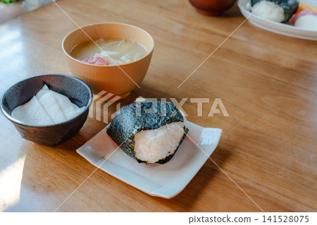 Japanese-style rice ball set with miso soup and side dishes Japanese-style rice ball set with miso soup and side dishes 141528075
