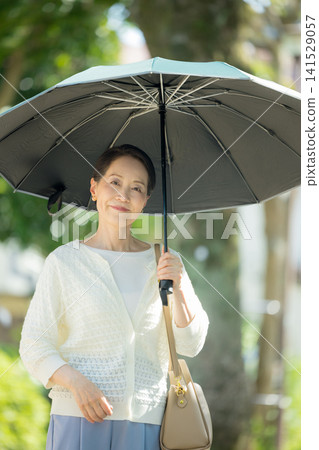 Senior woman sunblind Senior woman sunblind 141529057