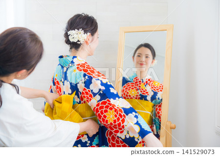 A woman in a yukata A woman in a yukata 141529073