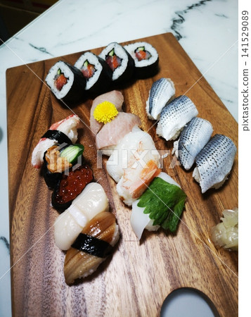 I tried arranging supermarket sushi on a cutting board. I tried arranging supermarket sushi on a cutting board. 141529089