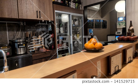 A view of the counter and kitchen of a small restaurant. A view of the counter and kitchen of a small restaurant. 141529715
