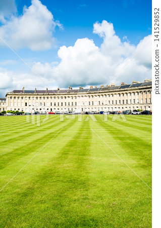 The historic honey-colored stone building of the Royal Crescent, part of the Bath cityscape, a UNESCO World Heritage Site in the UK. The historic honey-colored stone building of the Royal Crescent, part of the Bath cityscape, a UNESCO World Heritage Site in the UK. 141529852
