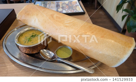 Large dosa and curry from South Indian cuisine Large dosa and curry from South Indian cuisine 141529933