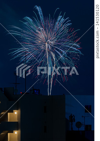 The Sumida River Fireworks Festival, visible beyond the buildings of downtown Tokyo – a quintessential Japanese scene. 141530120