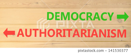 Democracy or authoritarianism words symbol. Concept words Democracy Authoritarianism on beautiful wooden wall. Beautiful wooden wall background. Business democracy authoritarianism concept. Copy space Democracy or authoritarianism words symbol. Concept words Democracy Authoritarianism on beautiful wooden wall. Beautiful wooden wall background. Business democracy authoritarianism concept. Copy space 141530377