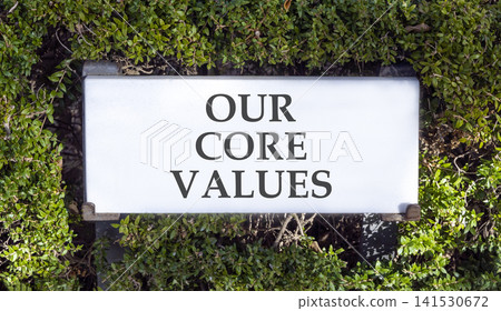 Our core values words symbol. Concept words Our core values on beautiful white sign plate. Beautiful green trees background. Business our core values motivational support concept. Copy space. Our core values words symbol. Concept words Our core values on beautiful white sign plate. Beautiful green trees background. Business our core values motivational support concept. Copy space. 141530672