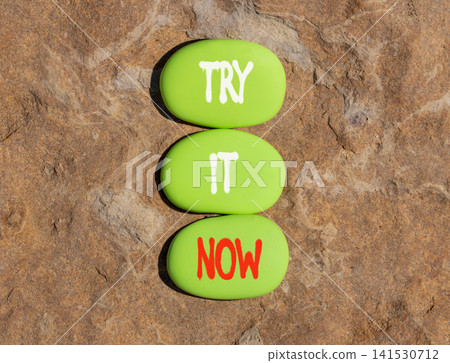 Try it now words symbol. Concept words Try is now on beautiful green stones. Beautiful stone background. Business support motivational and try is now concept. Copy space. 141530712