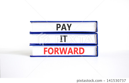 Pay it forward words symbol. Concept words Pay it forward on beautiful books. Beautiful white background. Business and pay it forward concept. Copy space. Pay it forward words symbol. Concept words Pay it forward on beautiful books. Beautiful white background. Business and pay it forward concept. Copy space. 141530737