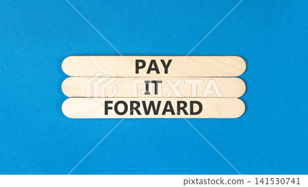Pay it forward words symbol. Concept words Pay it forward on beautiful wooden sticks. Beautiful blue background. Business and pay it forward concept. Copy space. Pay it forward words symbol. Concept words Pay it forward on beautiful wooden sticks. Beautiful blue background. Business and pay it forward concept. Copy space. 141530741