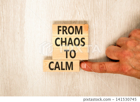 From chaos to calm symbol. Concept words From chaos to calm on beautiful wooden blocks. Beautiful grey background. Businessman hand. Business psychological from chaos to calm concept. Copy space. From chaos to calm symbol. Concept words From chaos to calm on beautiful wooden blocks. Beautiful grey background. Businessman hand. Business psychological from chaos to calm concept. Copy space. 141530745