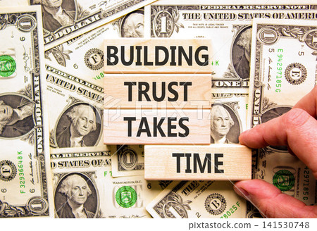 Building trust takes time words symbol. Concept words Building trust takes time on beautiful wooden blocks. Beautiful dollar bills background. Business building trust takes time concept. Copy space. Building trust takes time words symbol. Concept words Building trust takes time on beautiful wooden blocks. Beautiful dollar bills background. Business building trust takes time concept. Copy space. 141530748
