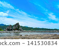 The red torii gate of the White Snake Benzaiten shrine stands amidst the unique rock formations of the Ukui Peninsula, against a backdrop of a dramatic blue sky (Nachikatsuura Town, Wakayama Prefecture). 141530834