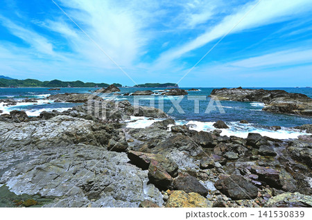 A spectacular view of Ojaura Coast, with its clear blue sky and dramatic rock formations (Nachikatsuura Town, Wakayama Prefecture). A spectacular view of Ojaura Coast, with its clear blue sky and dramatic rock formations (Nachikatsuura Town, Wakayama Prefecture). 141530839