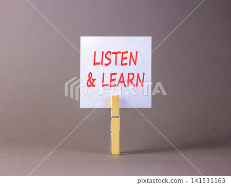 Listen and learn words symbol. Concept words Listen and learn on beautiful white paper on wooden clothespin. Beautiful grey background. Business listen and learn support concept. Copy space. Listen and learn words symbol. Concept words Listen and learn on beautiful white paper on wooden clothespin. Beautiful grey background. Business listen and learn support concept. Copy space. 141531163