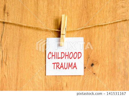 Childhood trauma words symbol. Concept words Childhood trauma on beautiful white paper on wooden clothespin. Beautiful wooden background. Psychological childhood trauma support concept. Copy space. Childhood trauma words symbol. Concept words Childhood trauma on beautiful white paper on wooden clothespin. Beautiful wooden background. Psychological childhood trauma support concept. Copy space. 141531167