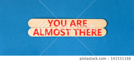You are almost there words symbol. Concept words You are almost there on beautiful wooden sticks. Beautiful blue background. Business You are almost there motivational support concept. Copy space. You are almost there words symbol. Concept words You are almost there on beautiful wooden sticks. Beautiful blue background. Business You are almost there motivational support concept. Copy space. 141531188