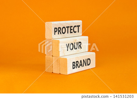 Protect your brand words symbol. Concept words Protect your brand on beautiful wooden blocks. Beautiful orange background. Business and protect your brand concept. Copy space. Protect your brand words symbol. Concept words Protect your brand on beautiful wooden blocks. Beautiful orange background. Business and protect your brand concept. Copy space. 141531203