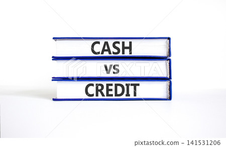 Cash vs credit words symbol. Concept words Cash vs credit on beautiful books. Beautiful white table white background. Business and cash vs credit concept. Copy space. Cash vs credit words symbol. Concept words Cash vs credit on beautiful books. Beautiful white table white background. Business and cash vs credit concept. Copy space. 141531206