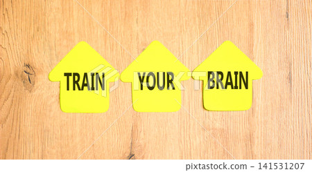 Train your brain words symbol. Concept words Train your brain on beautiful yellow paper houses. Beautiful wooden background. Business motivational train your brain concept. Copy space. Train your brain words symbol. Concept words Train your brain on beautiful yellow paper houses. Beautiful wooden background. Business motivational train your brain concept. Copy space. 141531207