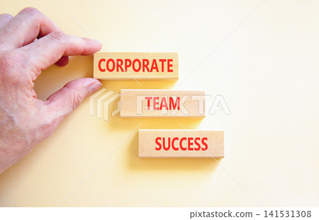 Corporate team success words symbol. Concept words Corporate team success on beautiful wooden blocks. Beautiful white background. Businessman hand. Business corporate team success concept Copy space 141531308