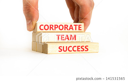 Corporate team success words symbol. Concept words Corporate team success on beautiful wooden blocks. Beautiful white background. Businessman hand. Business corporate team success concept Copy space 141531565
