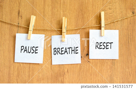 Pause breathe reset words symbol. Concept words Pause breathe reset on beautiful white papers. Beautiful wooden background. Business support motivational and pause breathe reset concept. Copy space. Pause breathe reset words symbol. Concept words Pause breathe reset on beautiful white papers. Beautiful wooden background. Business support motivational and pause breathe reset concept. Copy space. 141531577