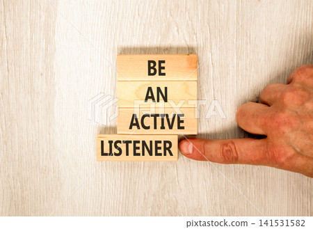 Be an active listener words symbol. Concept words Be an active listener on beautiful wooden blocks. Beautiful grey background. Businessman hand. Business be an active listener concept. Copy space. Be an active listener words symbol. Concept words Be an active listener on beautiful wooden blocks. Beautiful grey background. Businessman hand. Business be an active listener concept. Copy space. 141531582