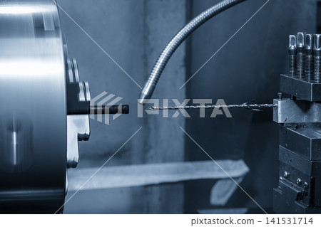 High-precision turning machine performing a small hole making process on a non-ferrous material part. 141531714