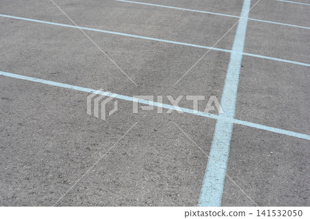 Empty parking lot grid with painted blue lines on asphalt Empty parking lot grid with painted blue lines on asphalt 141532050