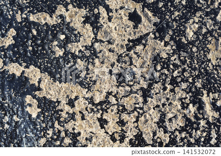 Weathered concrete surface with peeling black bitumen paint coating Weathered concrete surface with peeling black bitumen paint coating 141532072