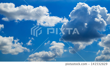 large dark cloud on the right side of a blue sky 141532829
