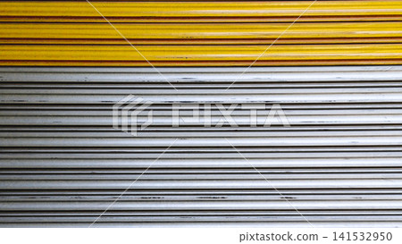 Abstract horizontal background of yellow and silver metal rolling shutter door with geometric parallel lines texture for web banner. 141532950